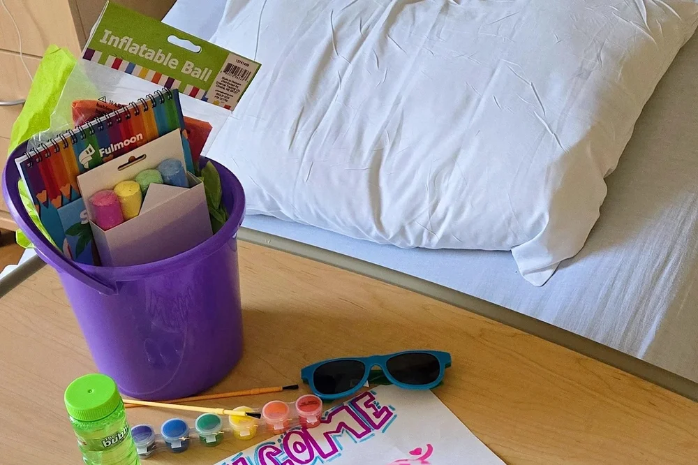 A care package of toys and comfort items delivered to a child&rsquo;s hospital bed