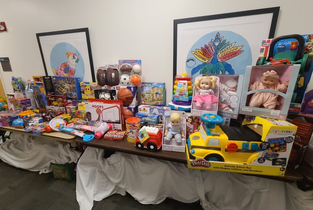 A table of donated toys and activities ready for delivery